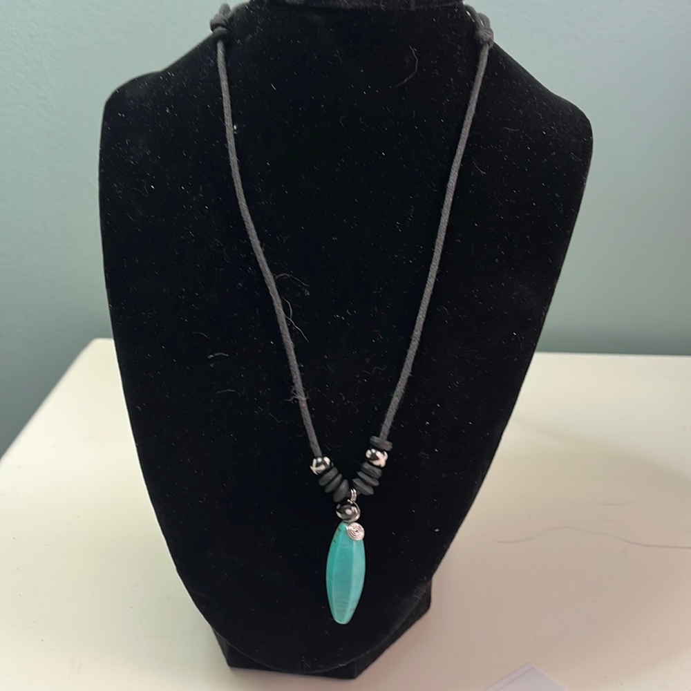 N58. Simple turquoise necklace on black string.